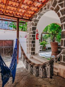 a hammock on the patio of a house at Hostel Casarão 65 in Salvador