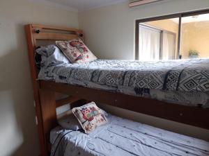 a bedroom with two bunk beds and a mirror at Santiago Apartotel Florida in Santiago
