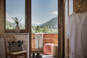 a room with a window with a view of a mountain at Biohotel Rastbichlhof in Neustift im Stubaital