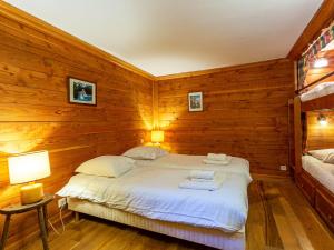 a bedroom with wooden walls and a bed with white sheets at Appartement Val-d'Isère, 3 pièces, 8 personnes - FR-1-694-122 in Val-d'Isère