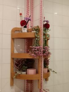 a shelf with flowers and candles in a room at Apartment in Centre of Lisbon in Lisbon