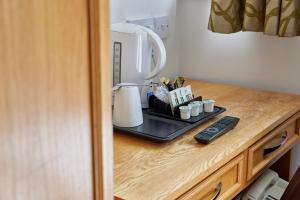 a counter with a coffee maker on a tray at Properties Unique Dene Rooms - Single Room in Newcastle upon Tyne