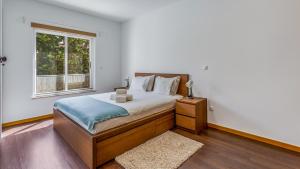 una camera con un grande letto e una finestra di Luminous 2 BDR Apartment W/Pool by LovelyStay ad Albufeira