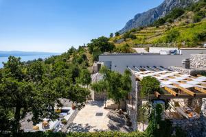 an overhead view of a white building with a hill at Villa Mountain Lodge in Omiš