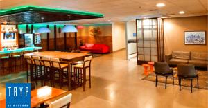 a living room with a bar and a couch at TRYP BY WYNDHAM São Paulo Airport - Hotel de Transito Terminal 3 INTERNACIONAL - Lado Ar - Área restrita á passageiros já embarcados e sem bagagens para despachar - Transit Hotel, only carry-on in Guarulhos