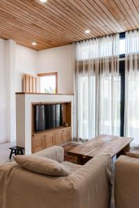 a living room with a table and a tv at Luxury Top Villa Alhambra Pool close to Sea and Centre in Benalmádena