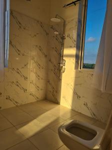un baño con inodoro y ducha en Five Seasons Zanzibar opposite Mnemba island Hotel, en Makunge 24 fotos más
