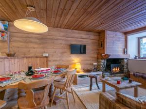 a living room with a table and a fireplace at Appartement Val-d'Isère, 3 pièces, 4 personnes - FR-1-694-313 in Val-d'Isère