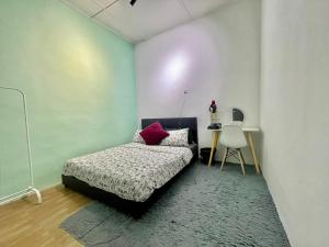 1 dormitorio con 1 cama y 1 mesa con silla en Cozy 18 Entire 3 Bedroom @Alma Bukit Mertajam, en Bukit Mertajam