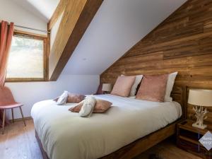 a bedroom with a large bed with wooden walls at Appartement Courchevel, 5 pièces, 8 personnes - FR-1-664-21 in Courchevel