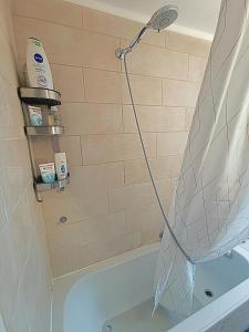 a shower head in a bathroom with a tub at Bed and Breakfast Lek & Jo 