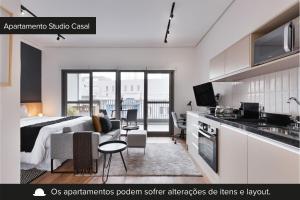 a kitchen and a living room with a bed and a couch at Charlie Edição Jardim Paulista in Sao Paulo