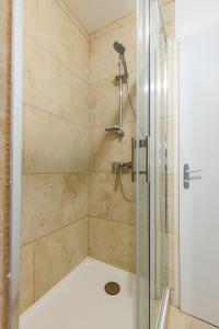 a bathroom with a shower with a glass door at La Suite Littéraire, 5mn du ZooParc de Beauval in Saint-Aignan