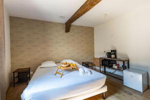 a bedroom with a bed with a tray of fruit on it at La Suite Littéraire, 5mn du ZooParc de Beauval in Saint-Aignan +3 photos