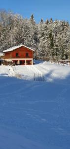 a house in the snow in front of a yard at gite haut Jura in Chaux-des-Crotenay