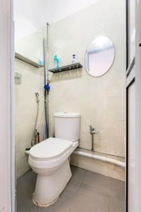 a bathroom with a toilet and a mirror at Spacious Studio at citycentre in Singapore