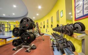 a gym with a row of dumbbells on a wall at villaggio olimpico in Sestriere