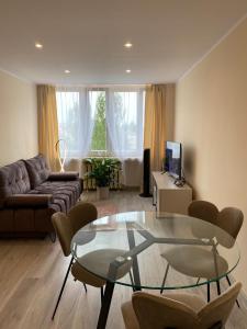 a living room with a couch and a glass table at CENTRAL Apartament Katowice/Spodek in Katowice