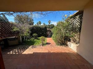 an entrance to a house with a brick walkway at San Teodoro Appartamento Vacanze Centro in San Teodoro