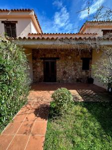 a house with a brick yard in front of it at San Teodoro Appartamento Vacanze Centro in San Teodoro