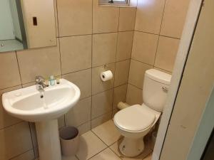 a bathroom with a toilet and a sink at Cube Hotel in Durban +63 photos