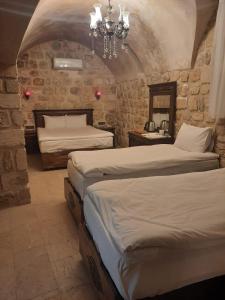 A bed or beds in a room at zerzevan hotel