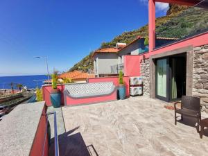 a balcony of a house with a view of the ocean at Chalé Esmeralda - Charming Studios in Calheta Beach in Calheta
