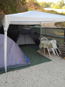 Canicattini BagniにあるAREA MULTISPORT Camping & Camperのテント(椅子2脚、テーブル付)