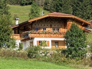 a large wooden house with a balcony on it at Zugspitzchalet in Lermoos