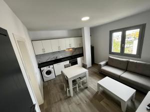 a living room with a couch and a table at H&A Guest House in Divjakë