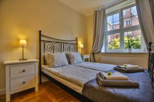 um quarto com uma cama com duas toalhas em Apartament Bursztynowy Mariacka Old Town em Gdansk