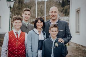 una familia de cuatro posando para una foto en Haus Birkenheim en Filzmoos