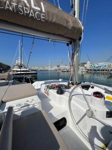 a boat is docked in the water in a harbor at Private Exclusive Catamaran 'Hang Loose' in Barcelona