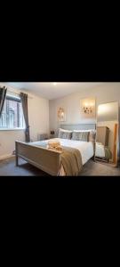 a bedroom with a large bed and a window at Glasshoughton Platinum in Castleford