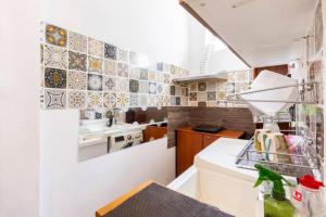a small kitchen with a sink and a dishwasher at Spacious Studio at citycentre in Singapore