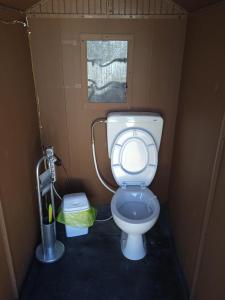 a small bathroom with a toilet in a stall at AREA MULTISPORT Camping & Camper in Canicattini Bagni