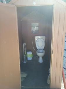 a small bathroom with a toilet in a stall at AREA MULTISPORT Camping & Camper in Canicattini Bagni