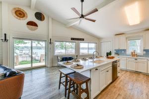 cocina con armarios blancos y ventilador de techo en Pet-Friendly Lake Norman Home with Boat Dock!, en Mooresville