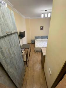 a room with a bed and a room with a sliding door at Квартира у моря Колхида in Makhinjauri