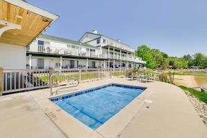 a swimming pool in front of a house at Beachfront Onekama Vacation Rental with Balcony! in Onekama