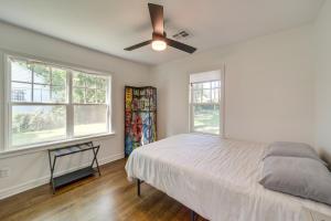 a bedroom with a bed and a ceiling fan at Central Tulsa Cottage with Yard about 3 Mi to Downtown! in Tulsa