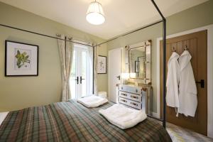 a bedroom with a bed and a dresser and a mirror at Glen View in Inverness