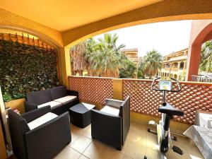 a balcony with chairs and a bike on a balcony at Malibu Village T2 in Canet-en-Roussillon