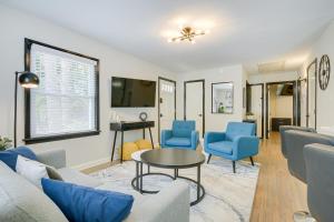 ein Wohnzimmer mit blauen Stühlen und einem Tisch in der Unterkunft Modern Raleigh Vacation Rental about 3 Mi to Downtown! in Raleigh
