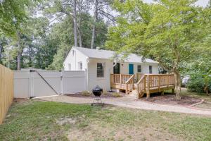 a house with a fence and a grill in the yard at Modern Raleigh Vacation Rental about 3 Mi to Downtown! in Raleigh