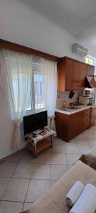 a kitchen with a couch and a table in a room at Panos & Maria studio! in Kalamata