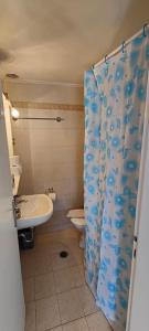 a bathroom with a toilet and a shower curtain at Panos & Maria studio! in Kalamata
