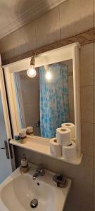 a bathroom with a sink and a mirror at Panos & Maria studio! in Kalamata