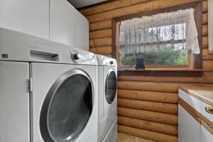 a washing machine in a kitchen with a window at 13655 County Road 1 in Ridgway