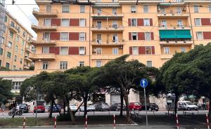 a large building with cars parked in front of it at Maison d'Or in Genoa